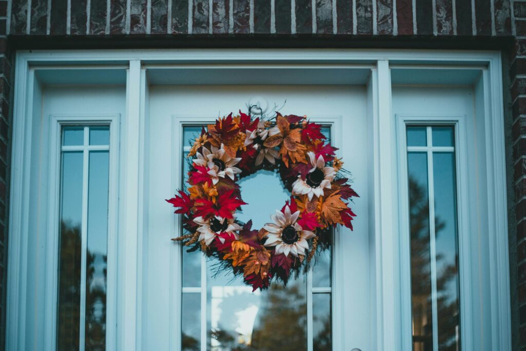 Colorful autumn wreath on a front door, capturing fall's festive charm.