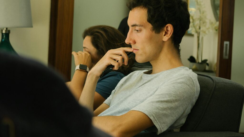 Two people sitting indoors, deep in thought and contemplation.