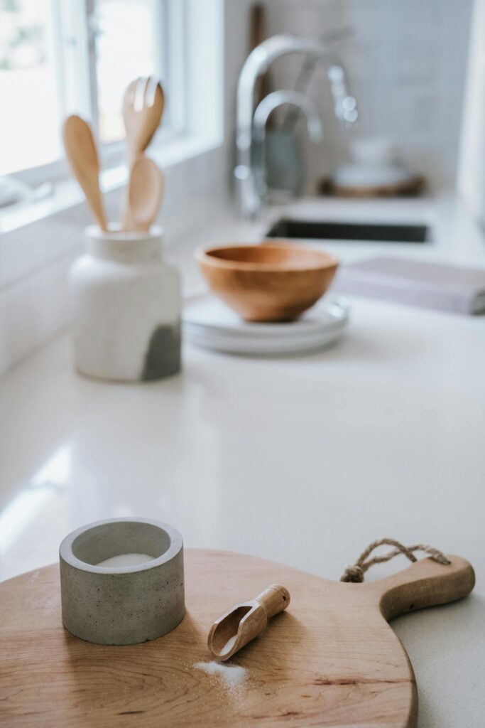 A serene Japandi-style kitchen featuring a wooden chopping board and modern utensils.